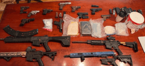 Seized Items including suspected cocaine, heroin, fentanyl, and handguns / long guns.